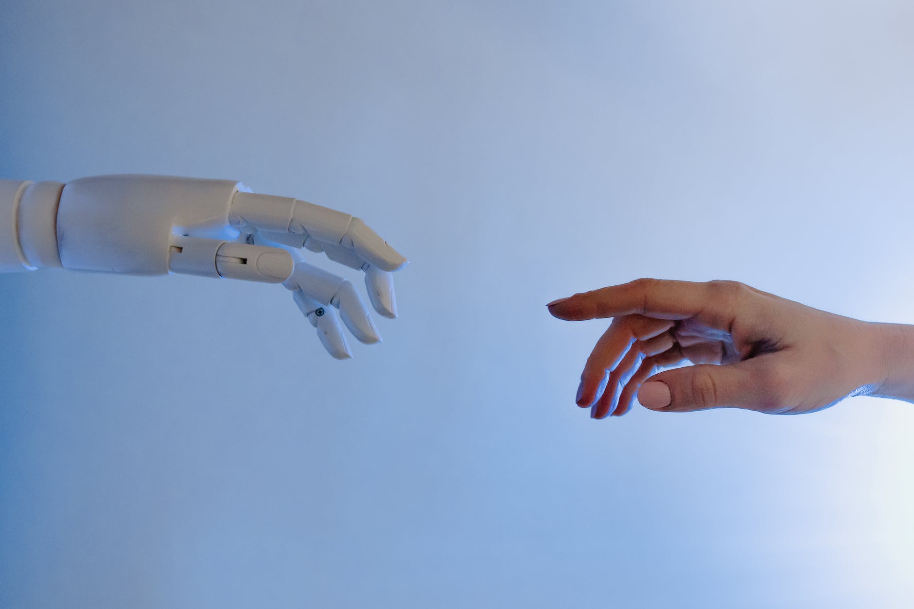 Robotic hand reaching out to a human hand.