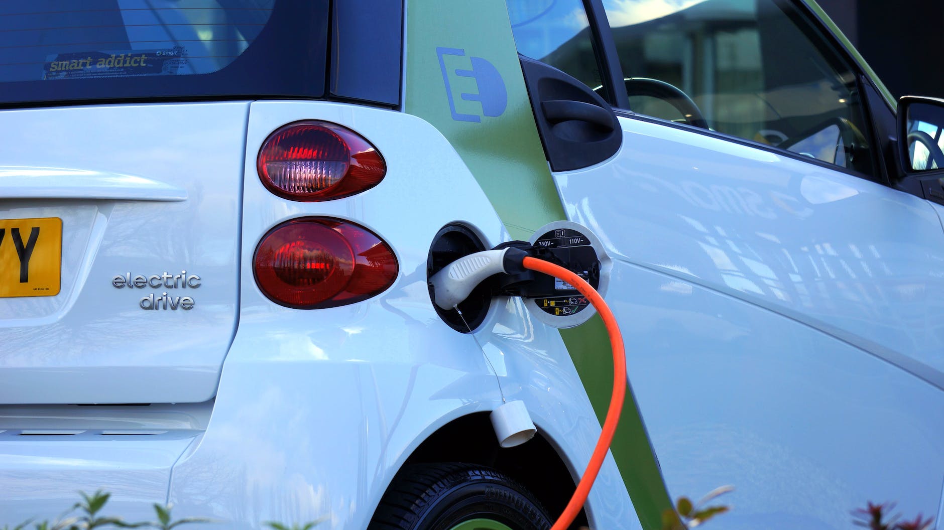 A white electric vehicle (EV) charging.