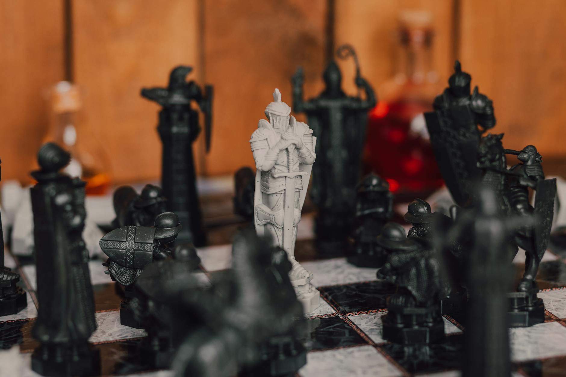 Chess board game showing a White Knight surrounded by Black chessmen.